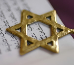 A Golden Star of David, a Jewish symbol, over the first word of the book of Genesis.